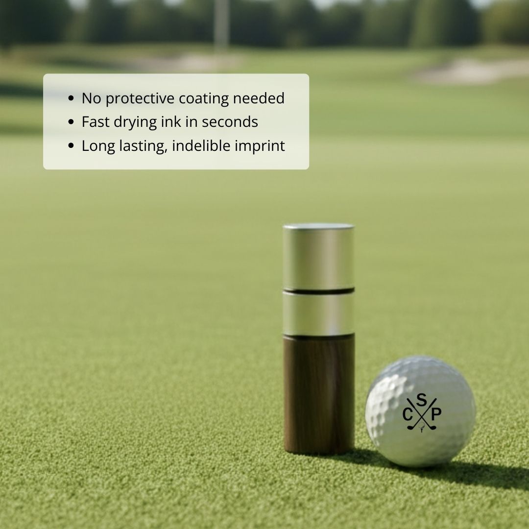Golf ball stamp with wooden handle shown next to white golf ball with sample monogram "CSP" and crossed clubs design on putting green