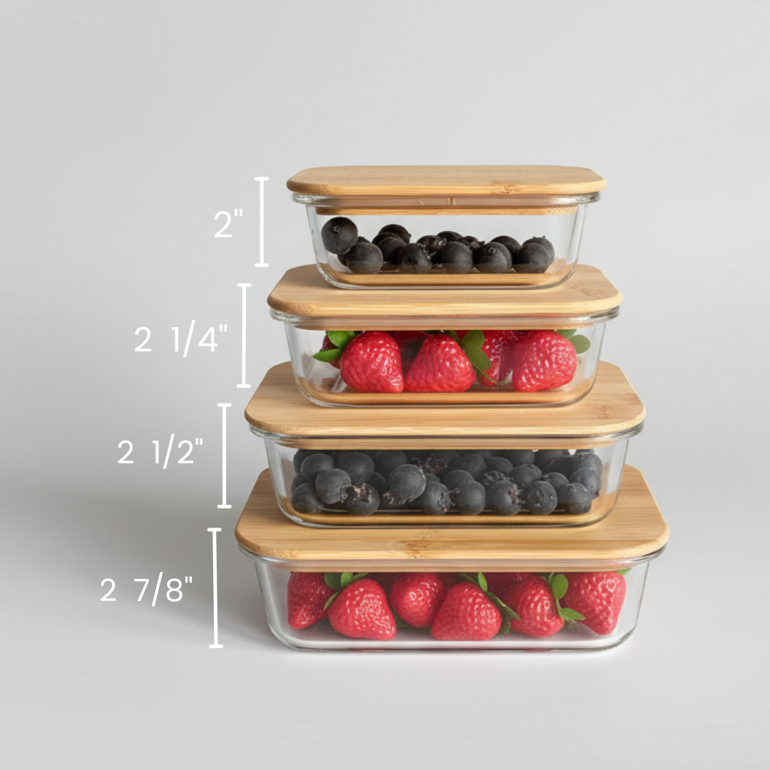 Four-piece glass food storage containers with bamboo lids, stacked and labeled with heights ranging from 2 inches to 2 7/8 inches, filled with berries for display