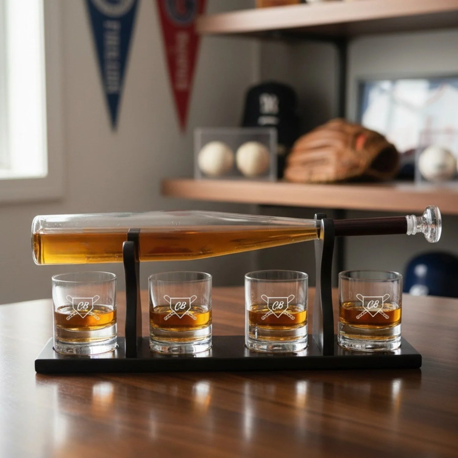 Baseball bat-shaped decanter filled with amber whiskey, tilted on mahogany stand above four whiskey glasses engraved with sample initials "CB" and crossed-bat design