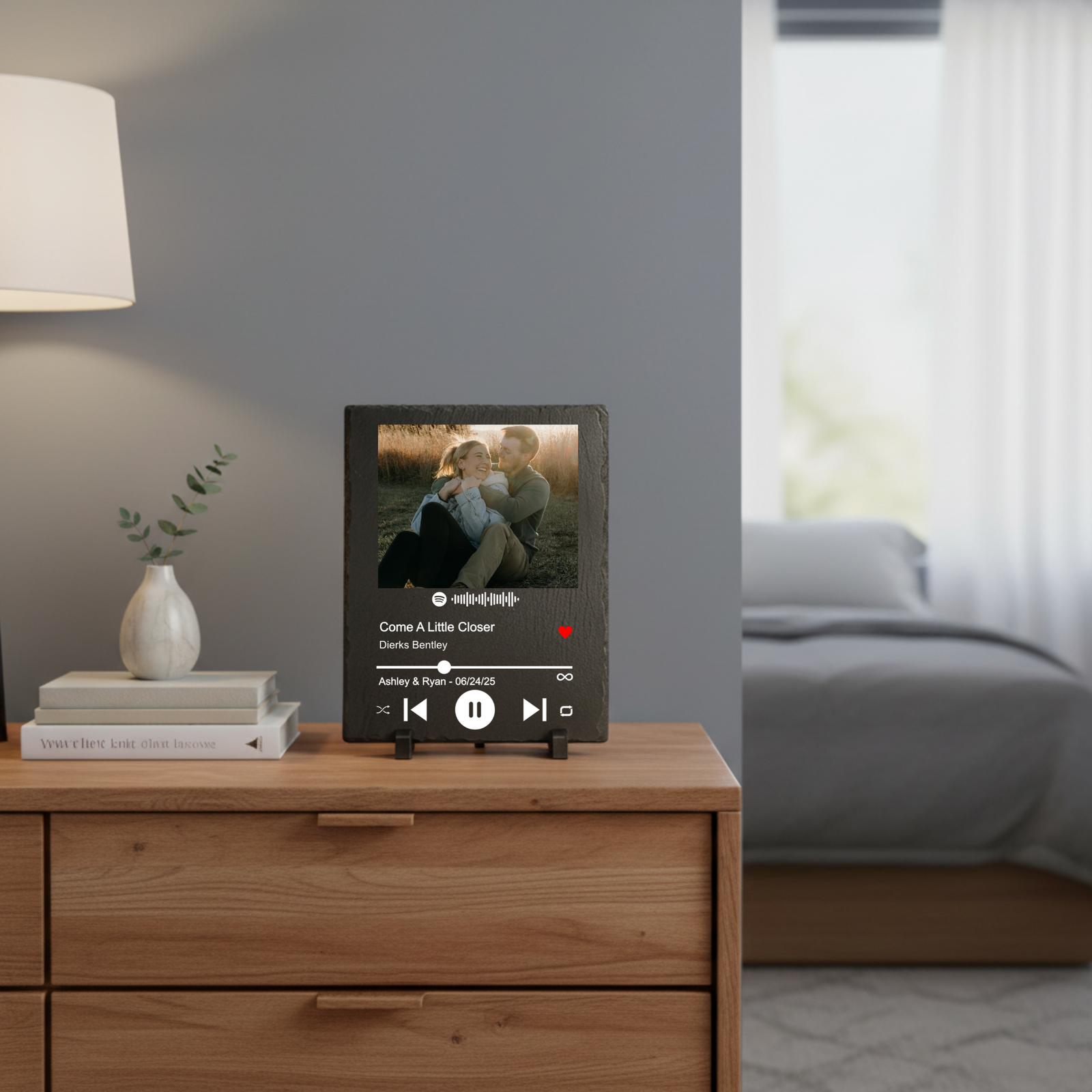 Personalized slate plaque displayed on wooden dresser showing sample photo with song details "Come A Little Closer" by Derks Bentley and customized names "Ashley & Ryan - 06/24/25