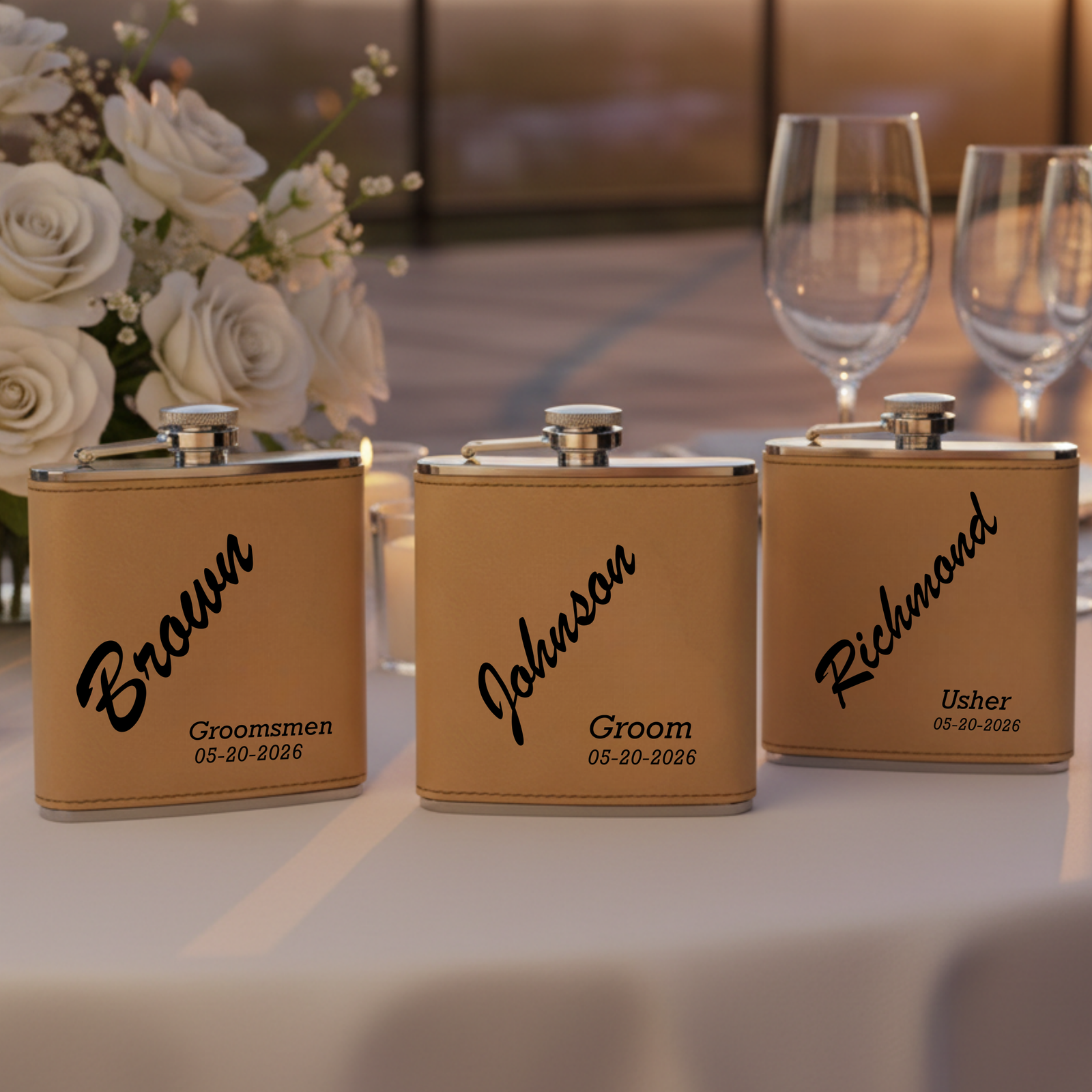 Three tan leatherette flasks with stainless steel caps lined up on white surface, each engraved with sample names "Braden," "Ashton," and "Richwood," with roles "Groomsmen," "Groom," and "Usher" and date "05-20-2026" below