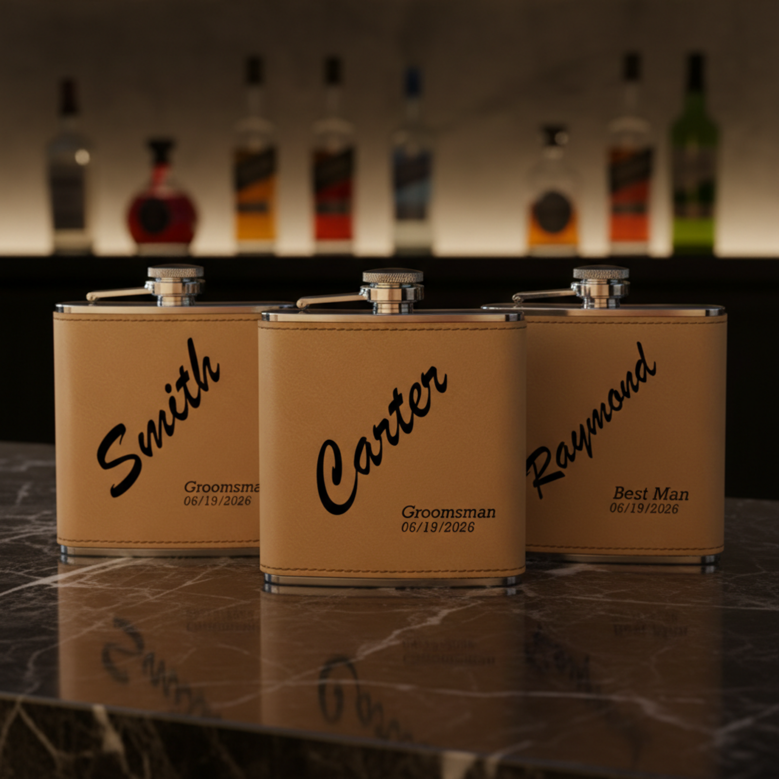 Three tan leatherette flasks with stainless steel caps, personalized with sample names "Smith," "Carter," and "Raymond" and dates 06/19/2026 engraved in black script.