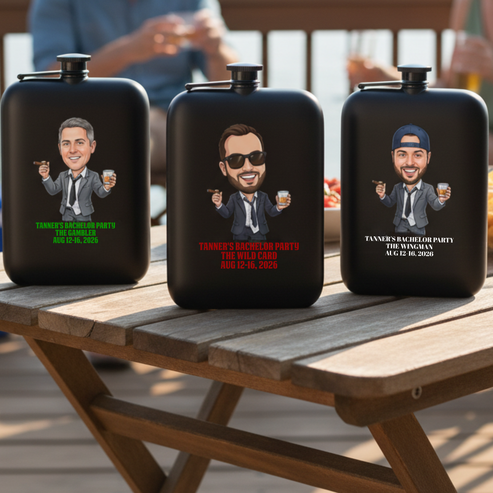 Three black flasks with custom caricature designs showing different male characters with personalized text examples including "The Gambler," "The Wild Card," and "The Wingman" with sample bachelor party dates displayed on wooden table outdoors.