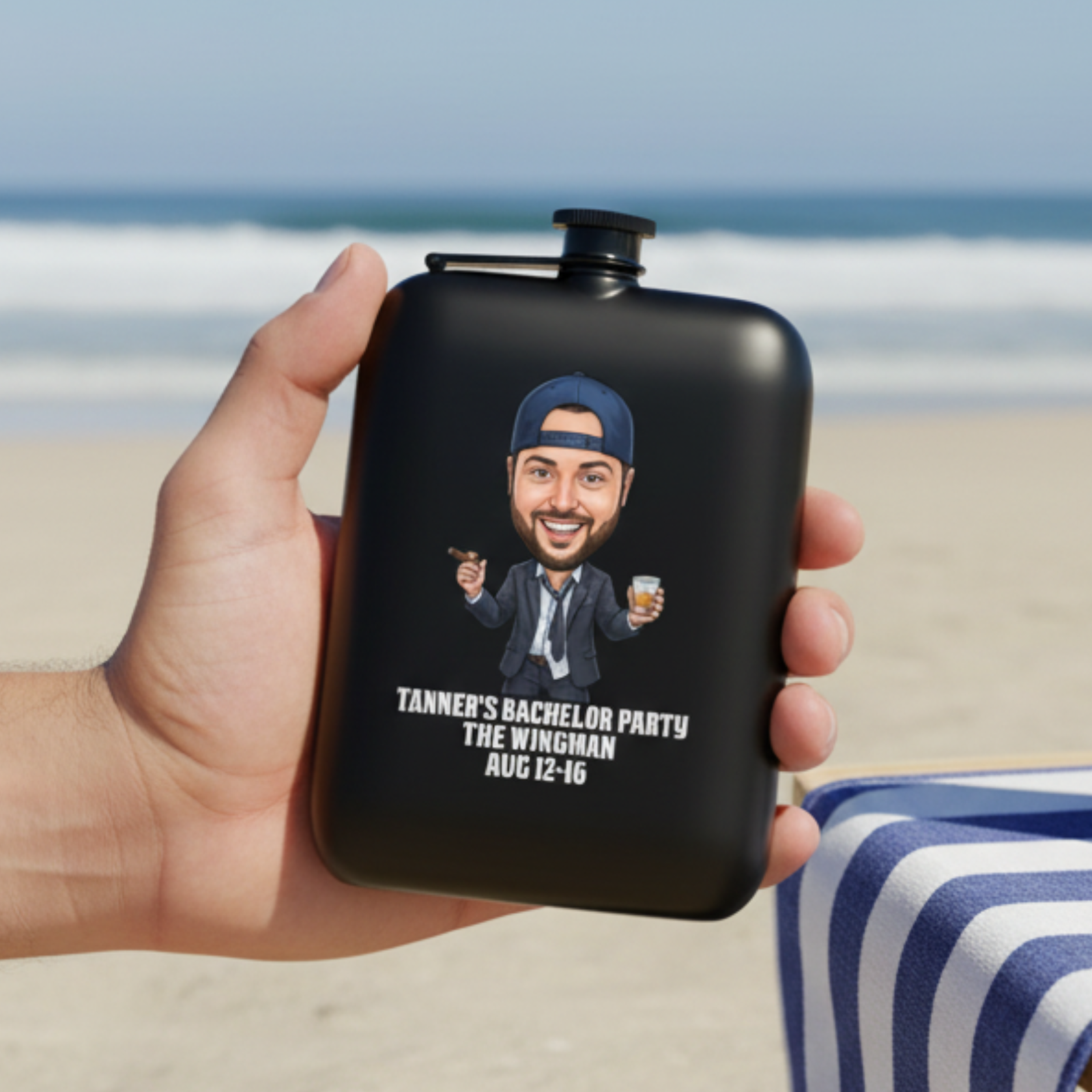 Black flask held in hand at beach, personalized with sample caricature illustration of man in blue cap and suit text reading "Tanner's Bachelor Party The Wingman Aug 12-16