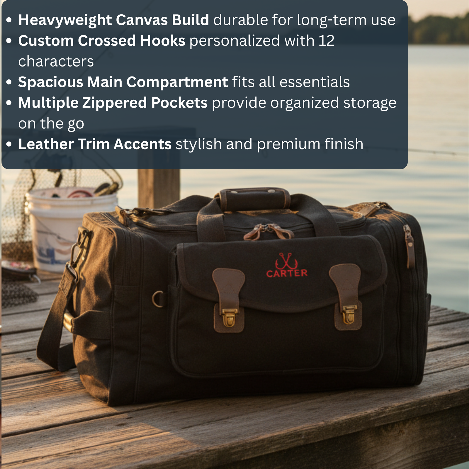 Black canvas duffel bag with leather handles and brass hardware, personalized with sample name "CARTER" in red lettering, positioned on wooden dock with water background