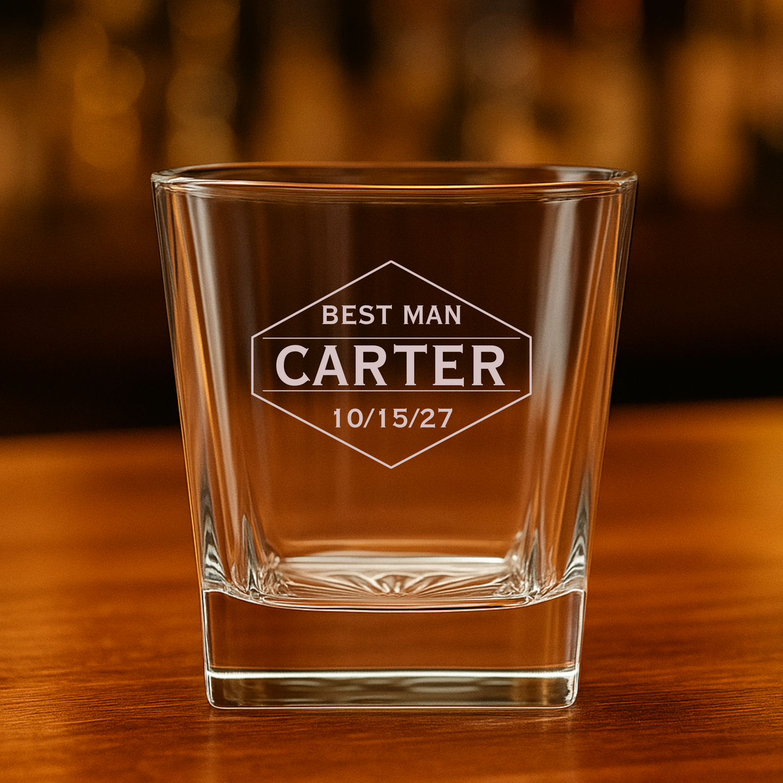 Engraved whiskey glass with groomsman name and wedding date on bar