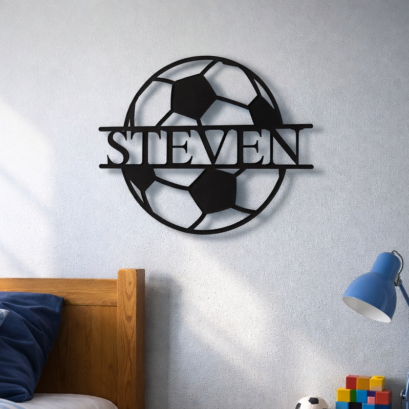 Laser-cut metal wall sign featuring a soccer ball design with personalized name "STEVEN" displayed across the center.