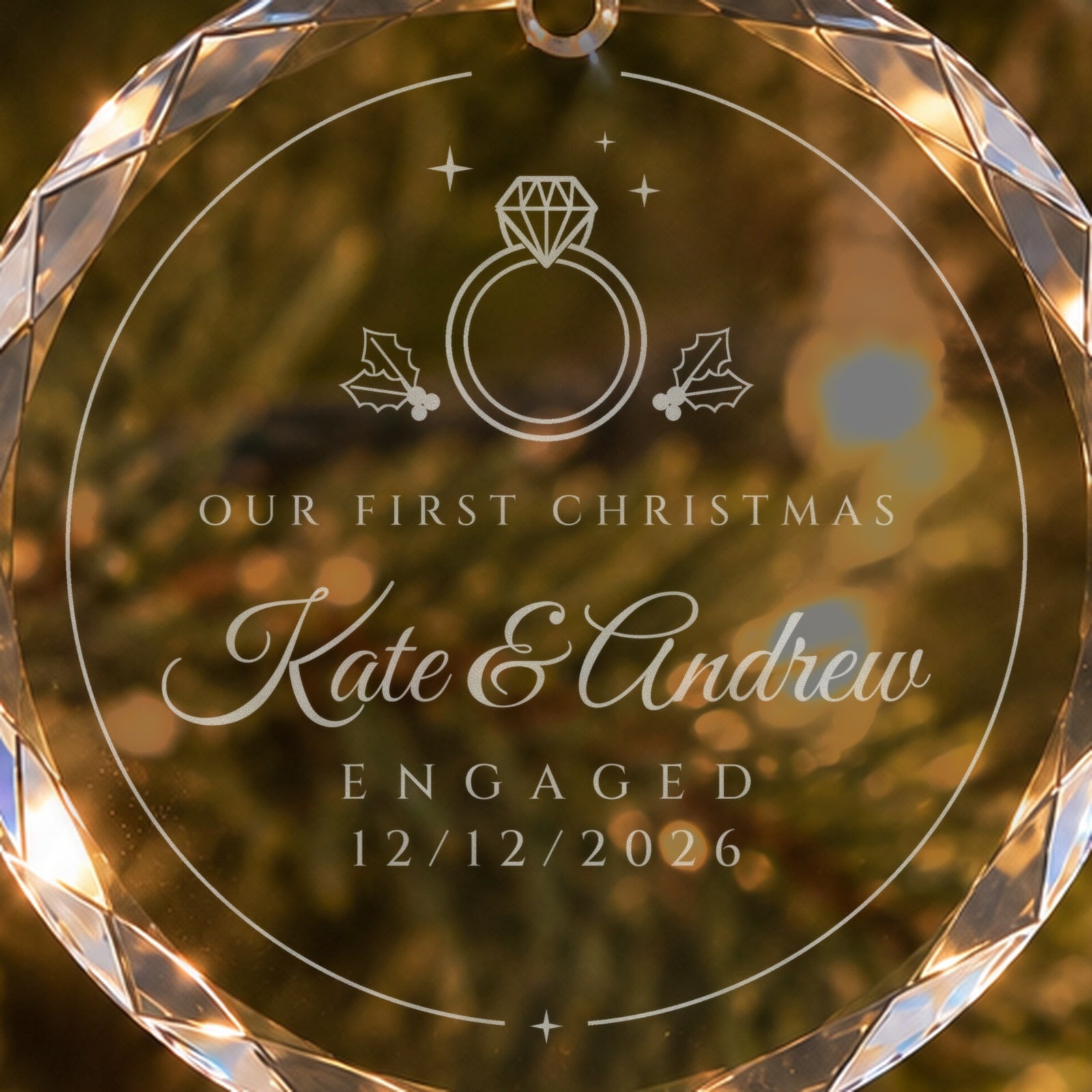 Close-up of the frosted engraving on the engagement ornament: solitaire ring between holly, OUR FIRST CHRISTMAS, Kate & Andrew, ENGAGED 12/12/2026