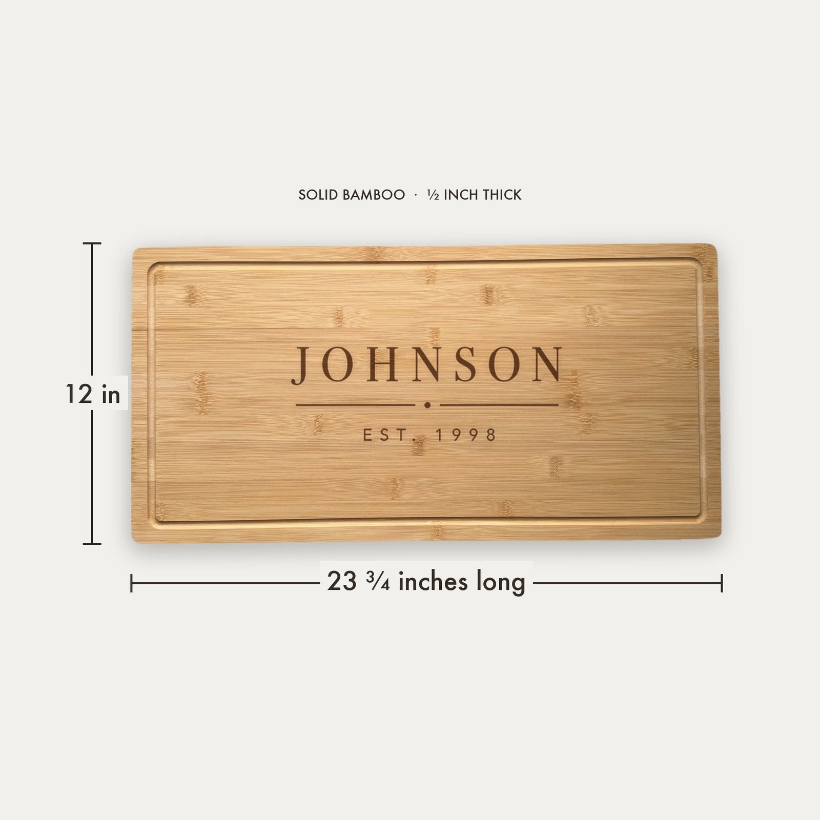 Size guide for the personalized last name cutting board, 23 and three quarter inches long by 12 inches wide in half inch thick solid bamboo.