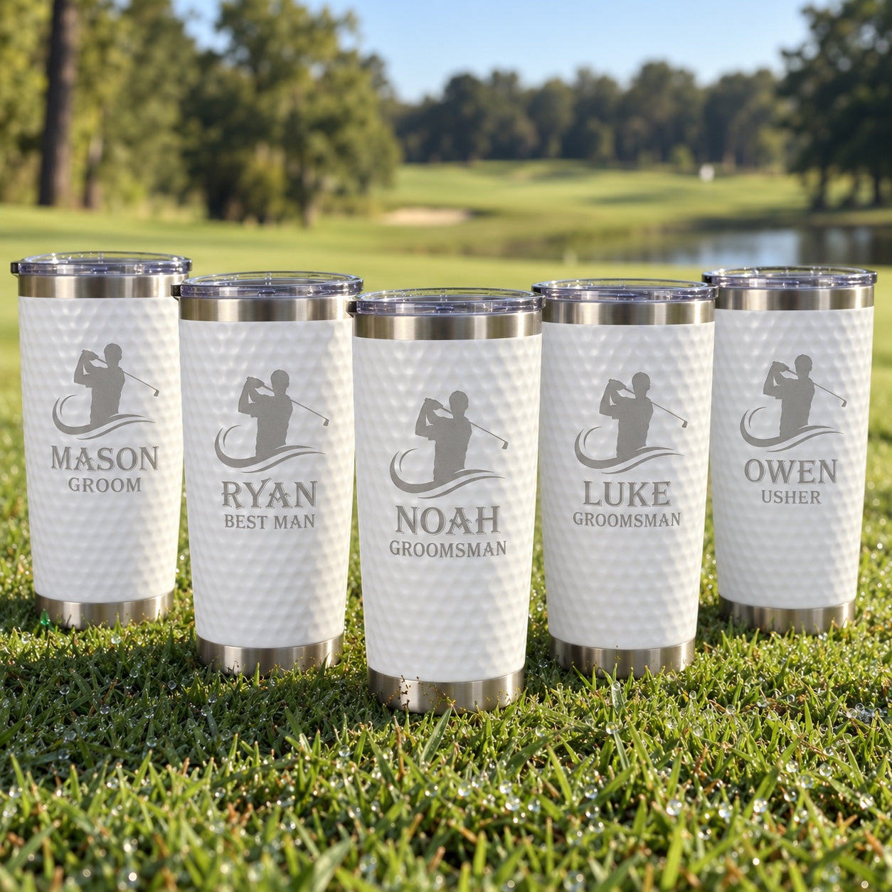 Five golf ball tumblers for the wedding party on a golf course, engraved MASON Groom, RYAN Best Man, NOAH and LUKE Groomsman and OWEN Usher.