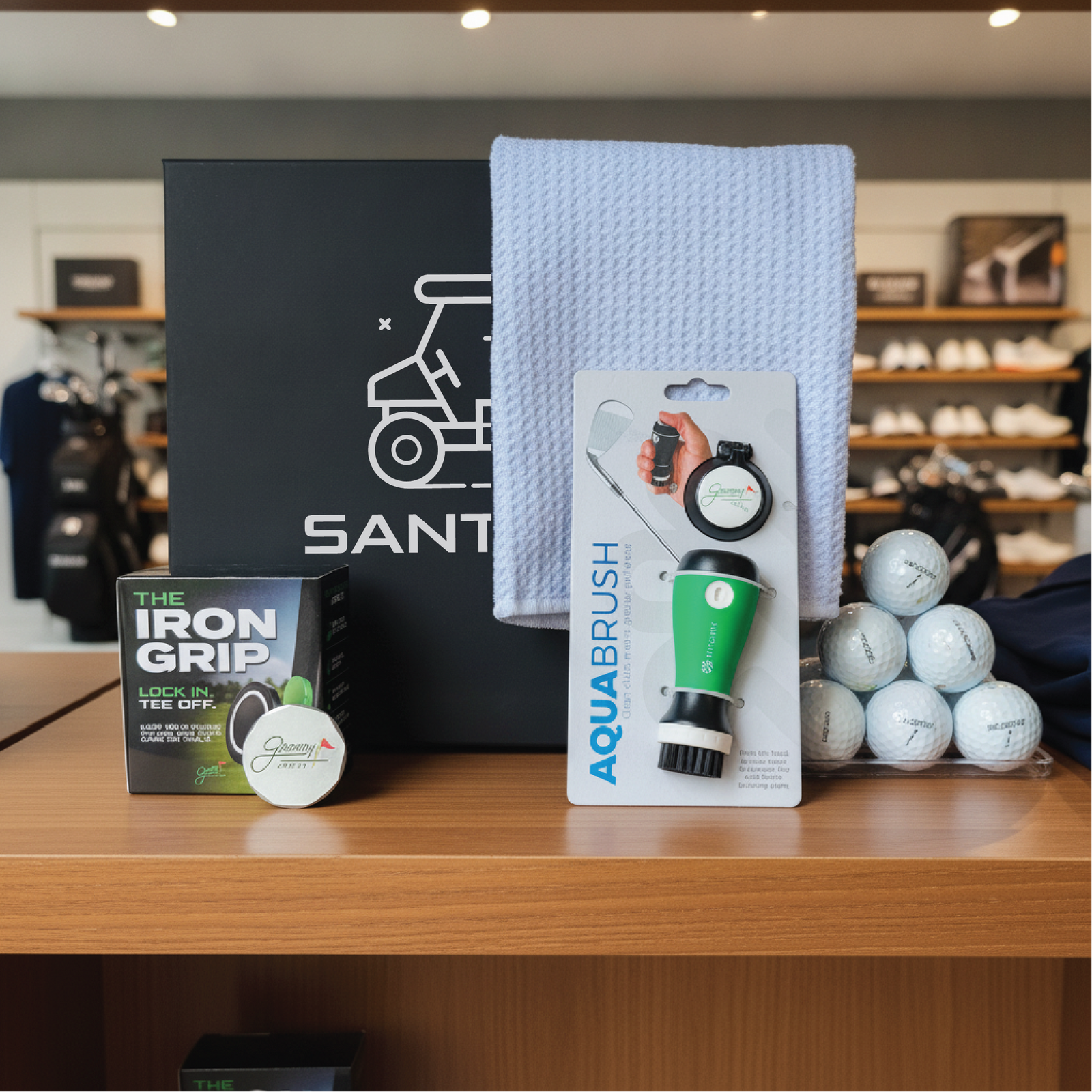 Personalized groomsman golf gift set, a keepsake box engraved with a name and filled with on-course golf accessories.