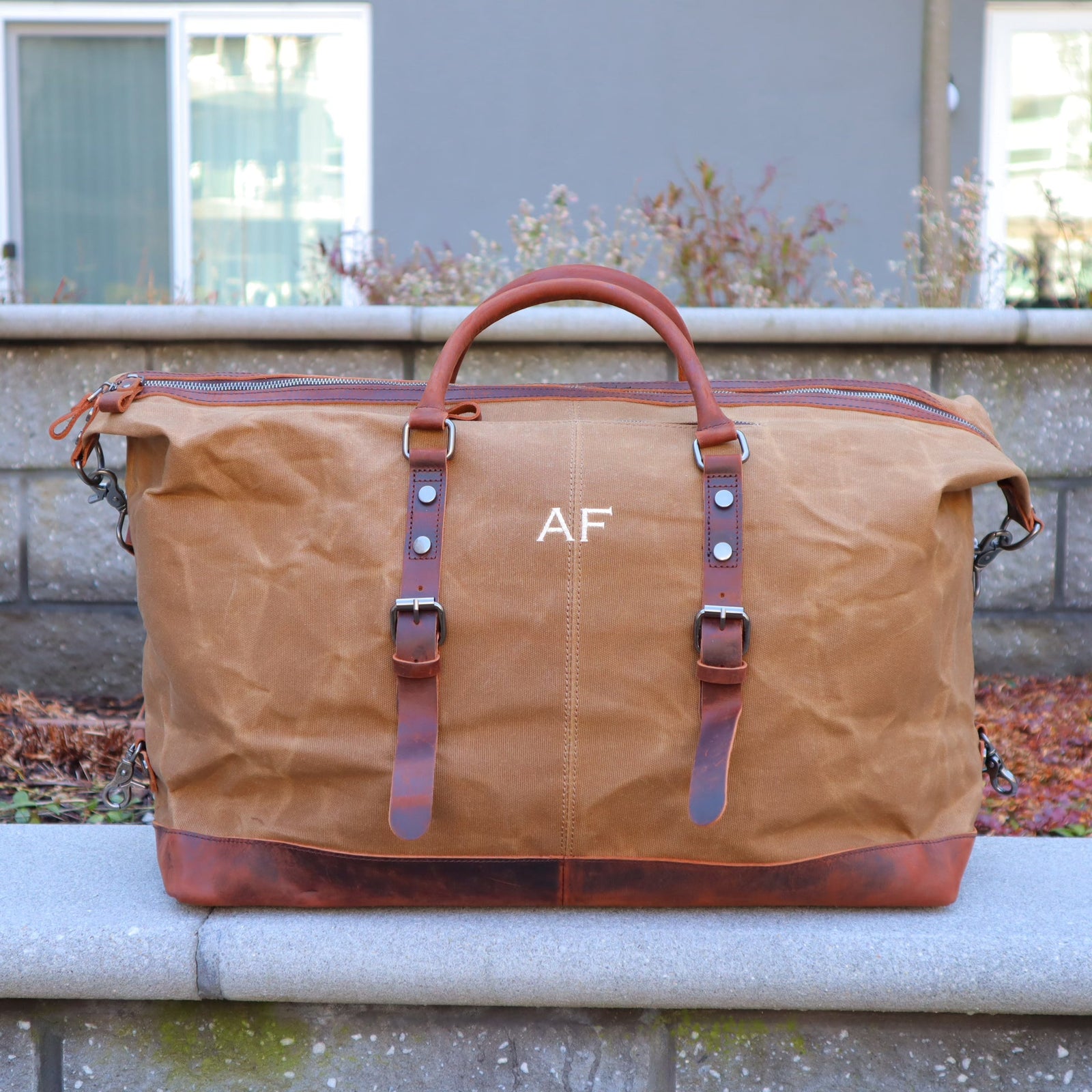 Personalized waxed canvas weekender bag with leather accents and monogram