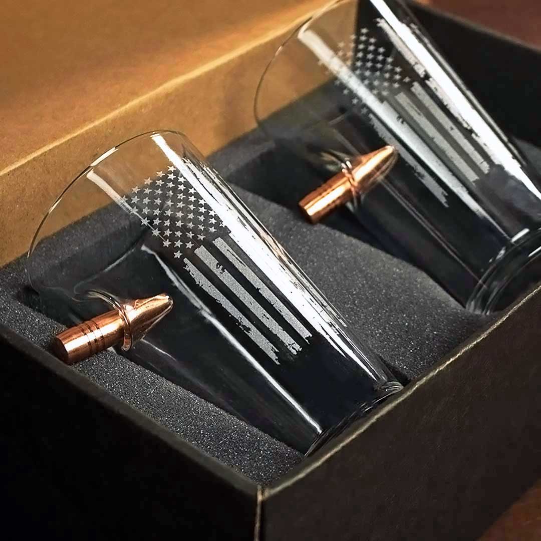 Pint glass with embedded .50 caliber bullet and etched American flag design