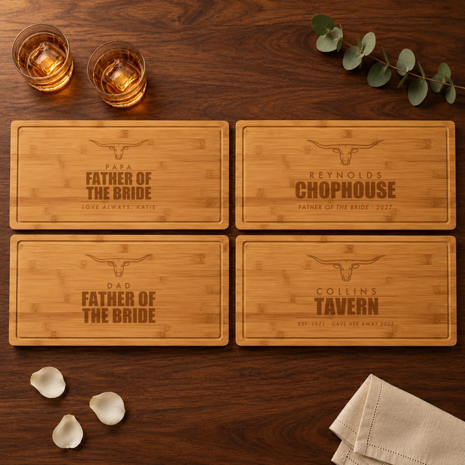 Four engraved father of the bride cutting boards on a rehearsal dinner table: Papa, Reynolds Chophouse, Dad and Collins Tavern, each with its own bottom line