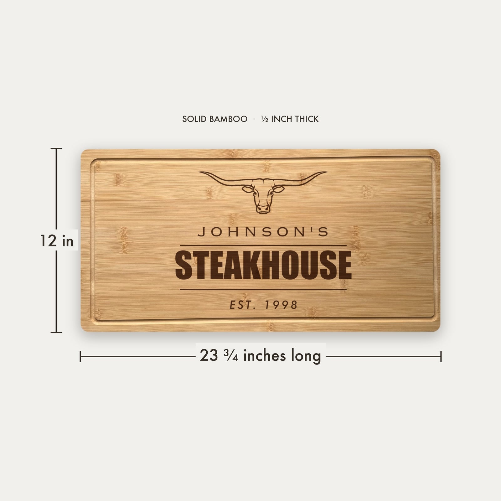 Size guide for the personalized steakhouse cutting board, 23 and three quarter inches long by 12 inches wide in half inch thick solid bamboo.