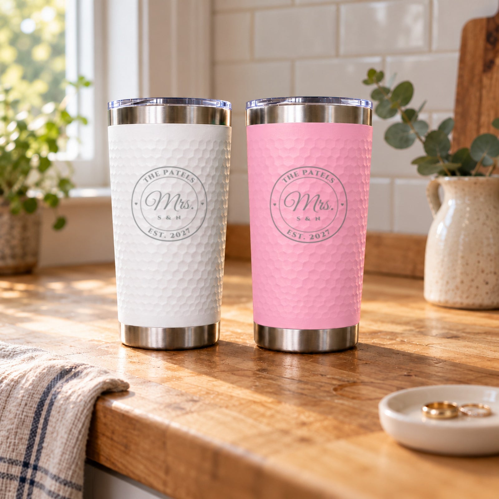 White and blush pink newlywed tumblers for The Patels, Est. 2027, engraved Mrs. and Mrs., a wedding gift from the bridal party