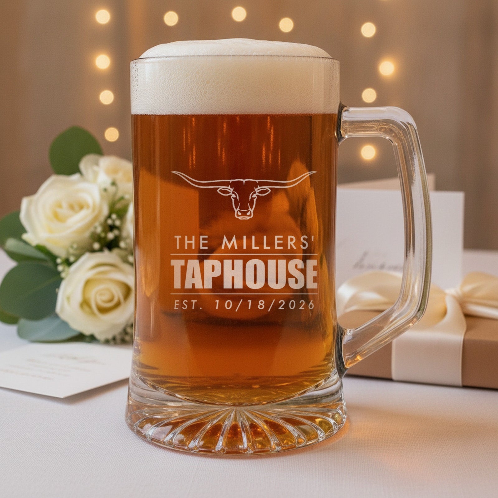 Personalized couples beer stein on a wedding gift table, engraved with a longhorn and The Millers' Taphouse, Est. 10/18/2026