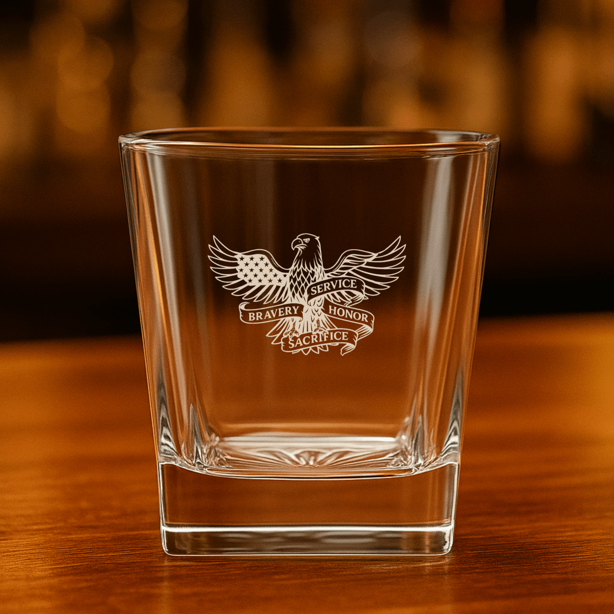 Whiskey glass with engraved eagle, American flag, and “Service, Bravery, Honor, Sacrifice” design