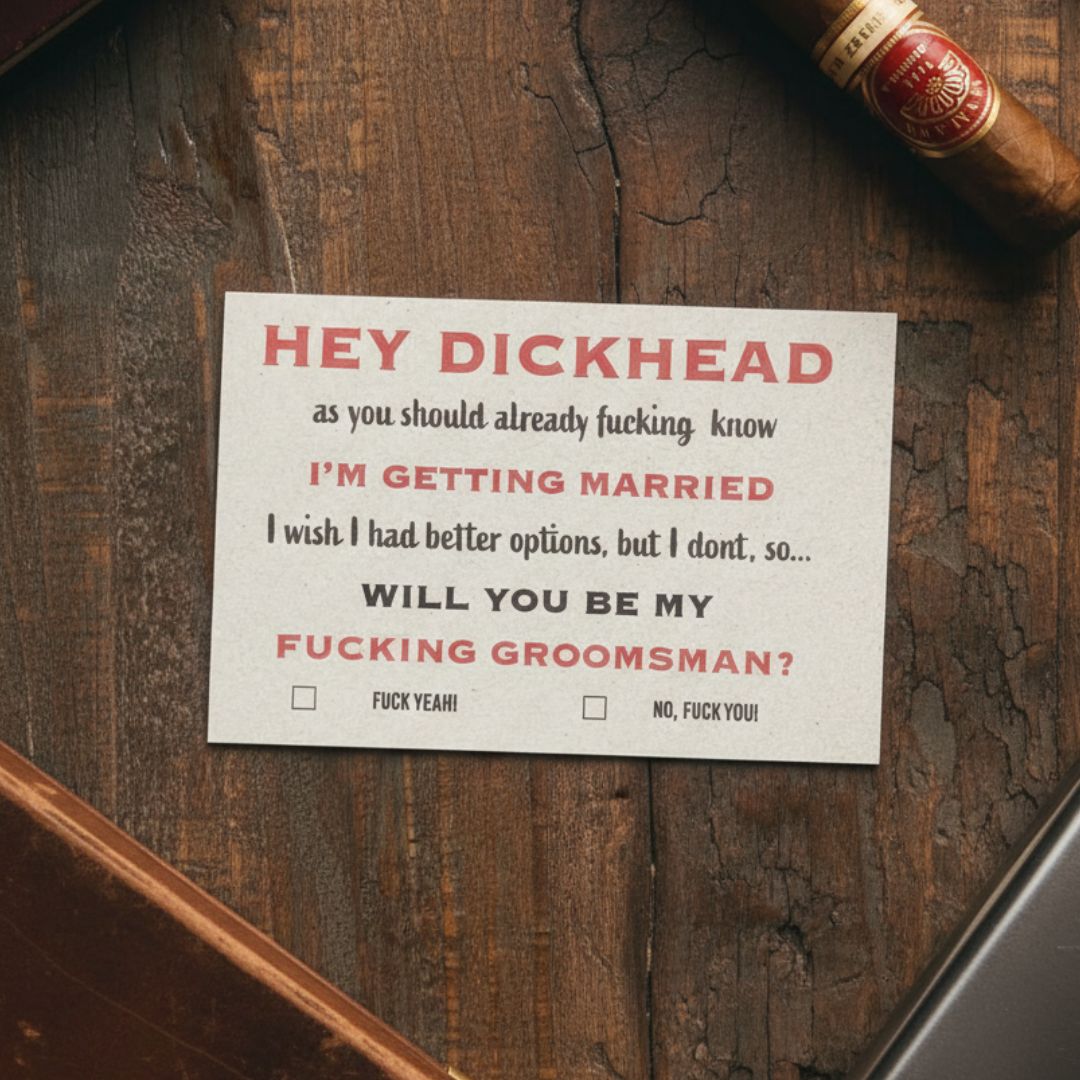 Humorous groomsmen proposal card with red and black text on cream cardstock, laid on distressed wood surface next to a cigar, with checkboxes for "Fuck Yeah!" and "No, Fuck You!" responses.