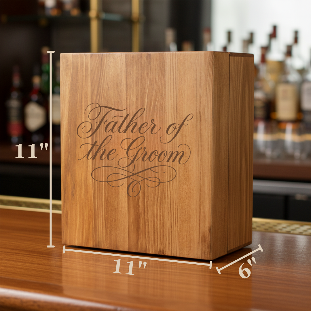 Light oak wooden decanter box with laser-engraved "Father of the Groom" script and flourish detail, shown with dimensions 11" height by 11" width by 6" depth on bar counter.
