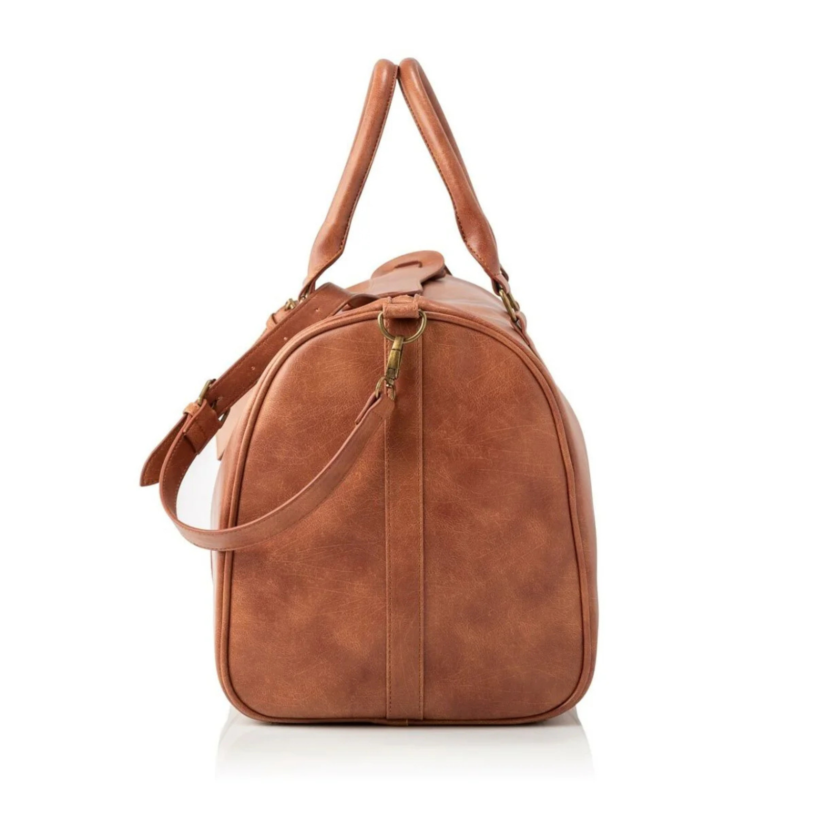 Cognac vegan leather duffle bag with dual shoulder straps, top handle, and brass hardware, shown from side angle