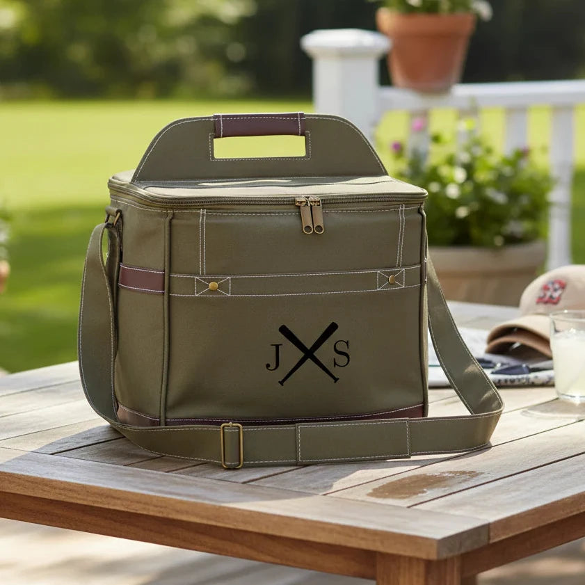 Green cooler bag with monogram on a wooden table outdoors