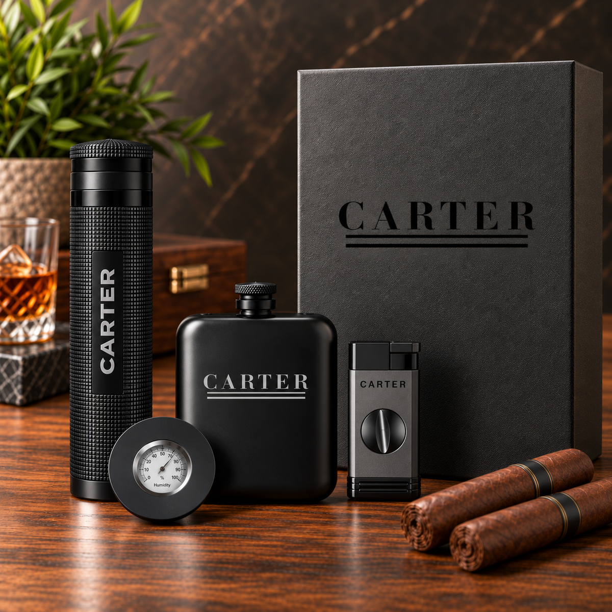 A luxury smoking accessory set by Carter on a dark wooden table, featuring a black flask, a textured black travel tumbler, a cigar lighter, a round thermometer, and a black gift box, styled with two cigars and a glass of whiskey.