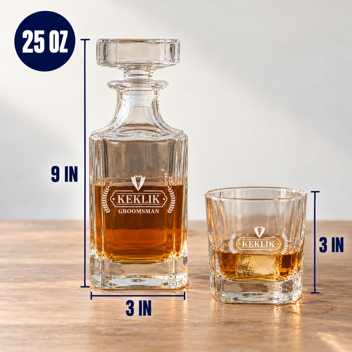 Pour Me One decanter beside an engraved rocks glass, with lines marking the decanter at 9 inches tall on a 3 inch base, the 3 inch glass and a 25 oz badge