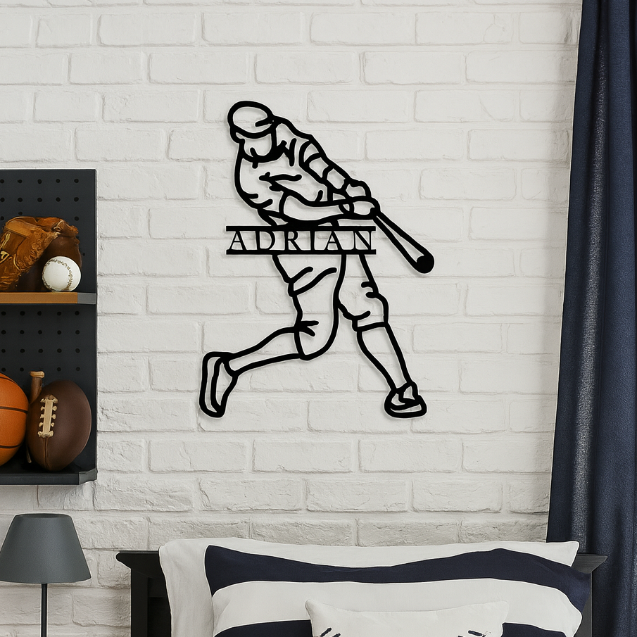 Black metal baseball player silhouette wall sign with sample name "ADRIAN" personalized across the torso, mounted on white brick wall