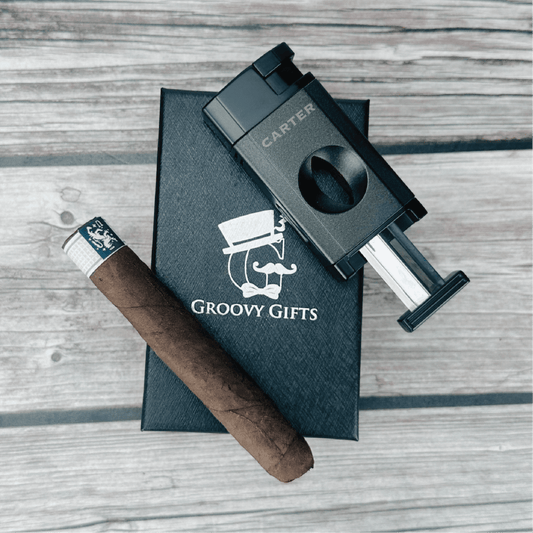 Cigar and cigar cutter on a 'Groovy Gifts' branded box on a wooden surface
