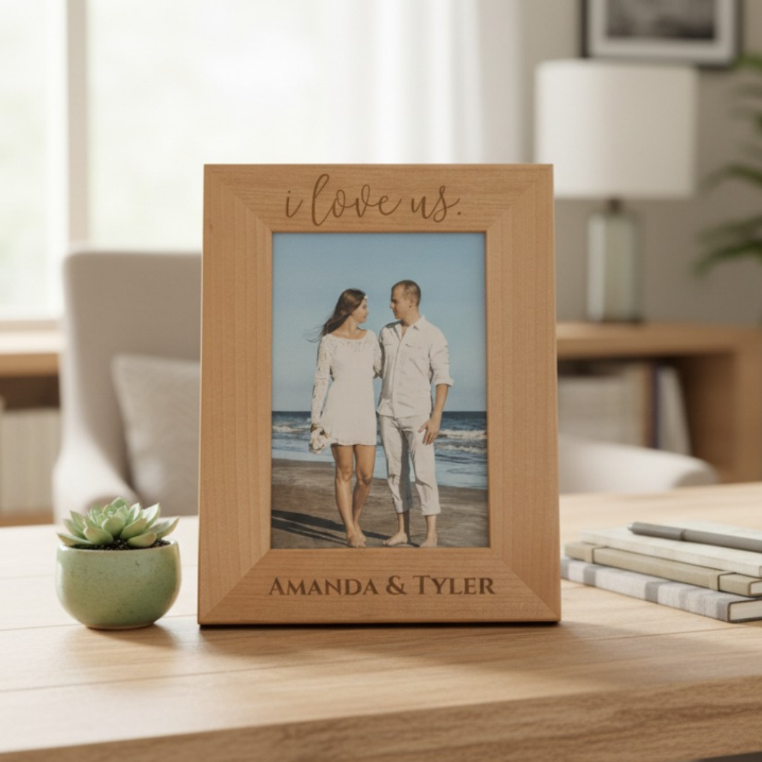 Wooden photo frame with 'i love us' and 'Amanda & Tyler' text, displaying a couple on a beach.