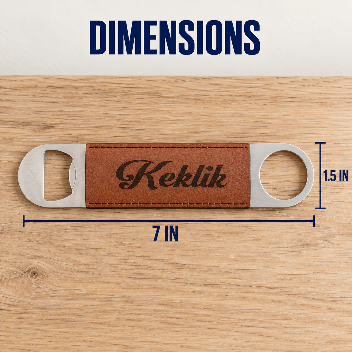 A bottle opener with a brown leather center strip engraved with the brand name 'Keklik' is shown on a wood surface, with dimension lines and text indicating 7 inches in length and 1.5 inches in height.