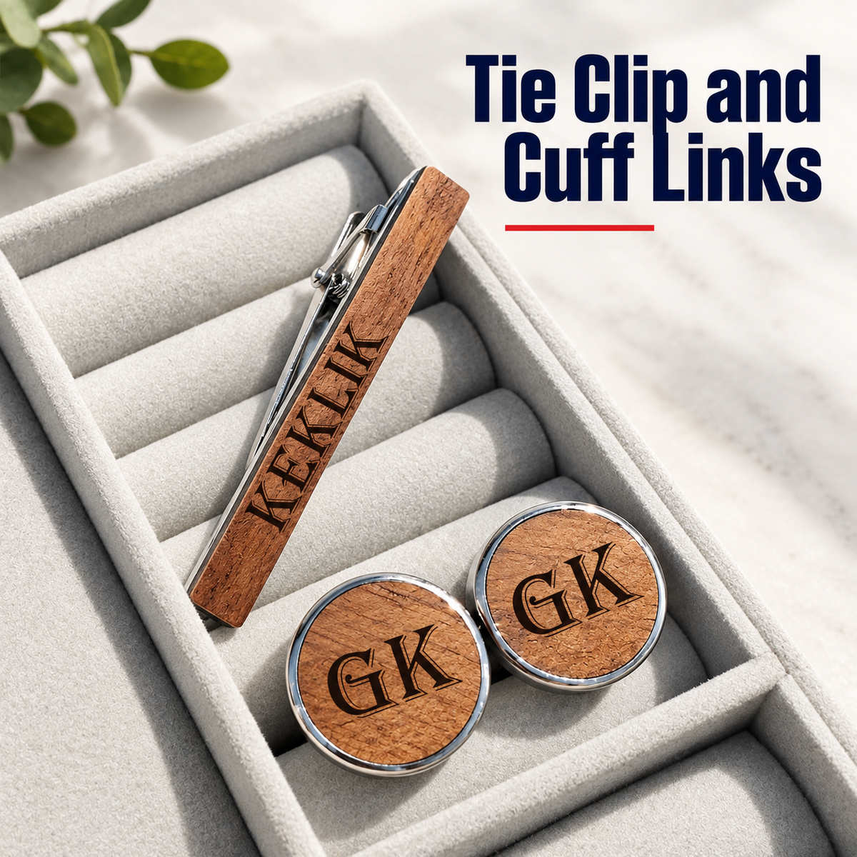 A personalized men's formal accessory set including a wooden tie clip and round cufflinks engraved with 'EKLIK' and 'GK' respectively, displayed in a light gray velvet jewelry box. The text 'Tie Clip and Cuff Links' is visible in the top right corner.