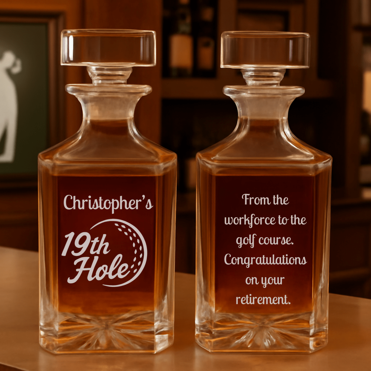 Two glass decanters with personalized inscriptions on a wooden surface.