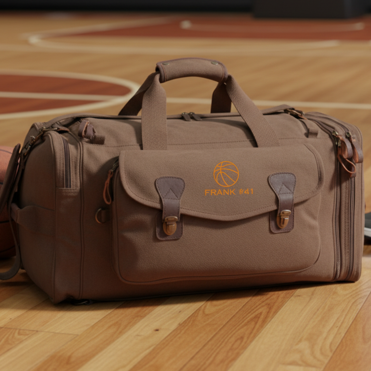 Brown canvas basketball duffle bag embroidered with a name on a hardwood court, a rugged personalized groomsman gift for a basketball fan.