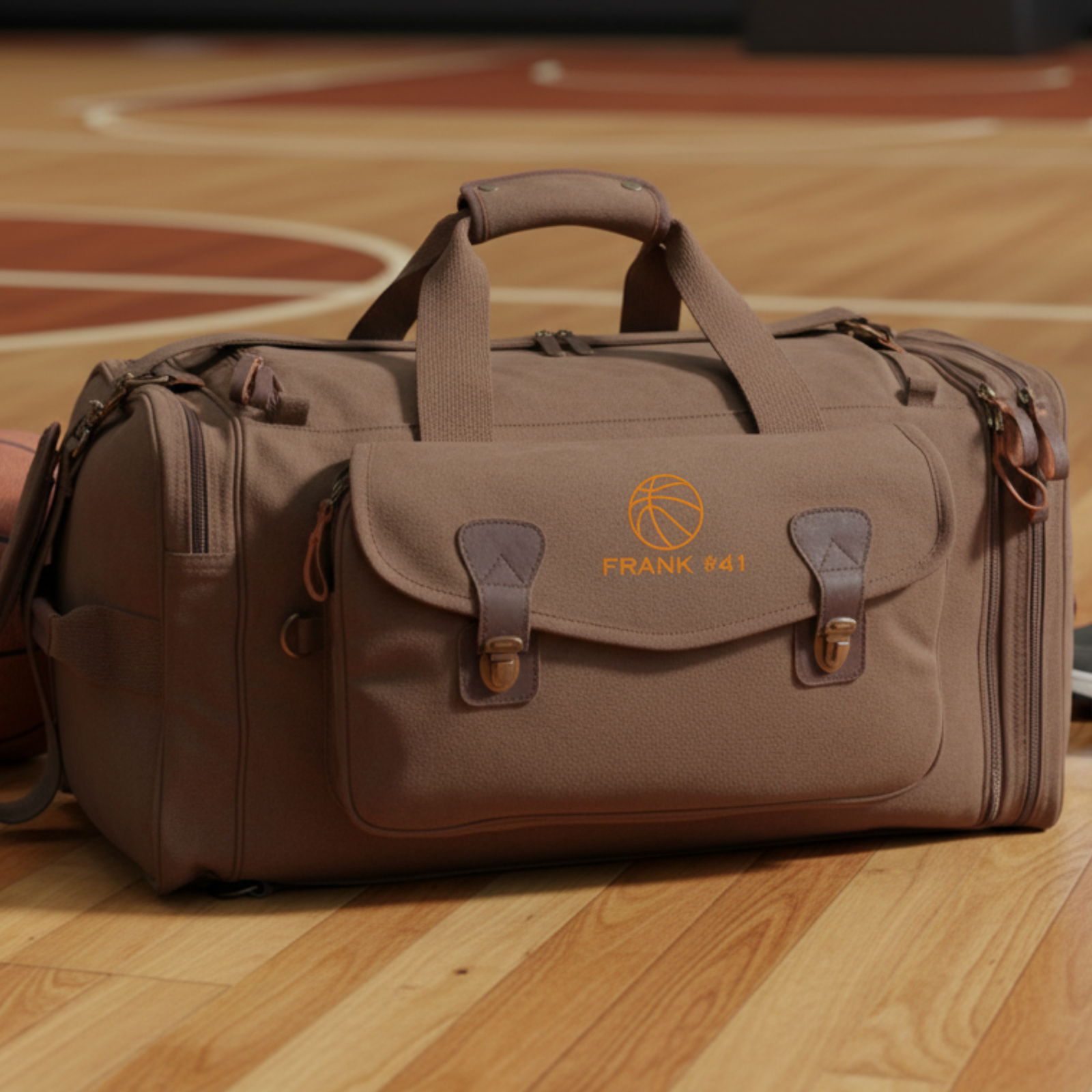 Brown canvas basketball duffle bag embroidered with a name on a hardwood court, a rugged personalized groomsman gift for a basketball fan.