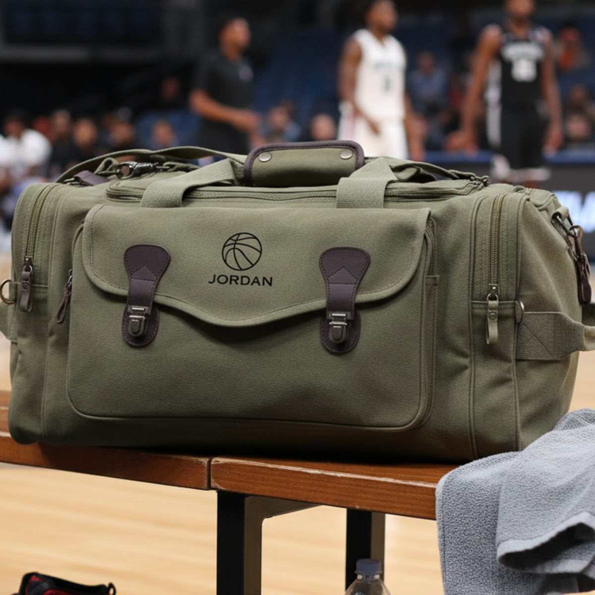 Olive green canvas basketball duffle bag embroidered with a name on a courtside bench, a personalized groomsmen gift for a basketball fan.