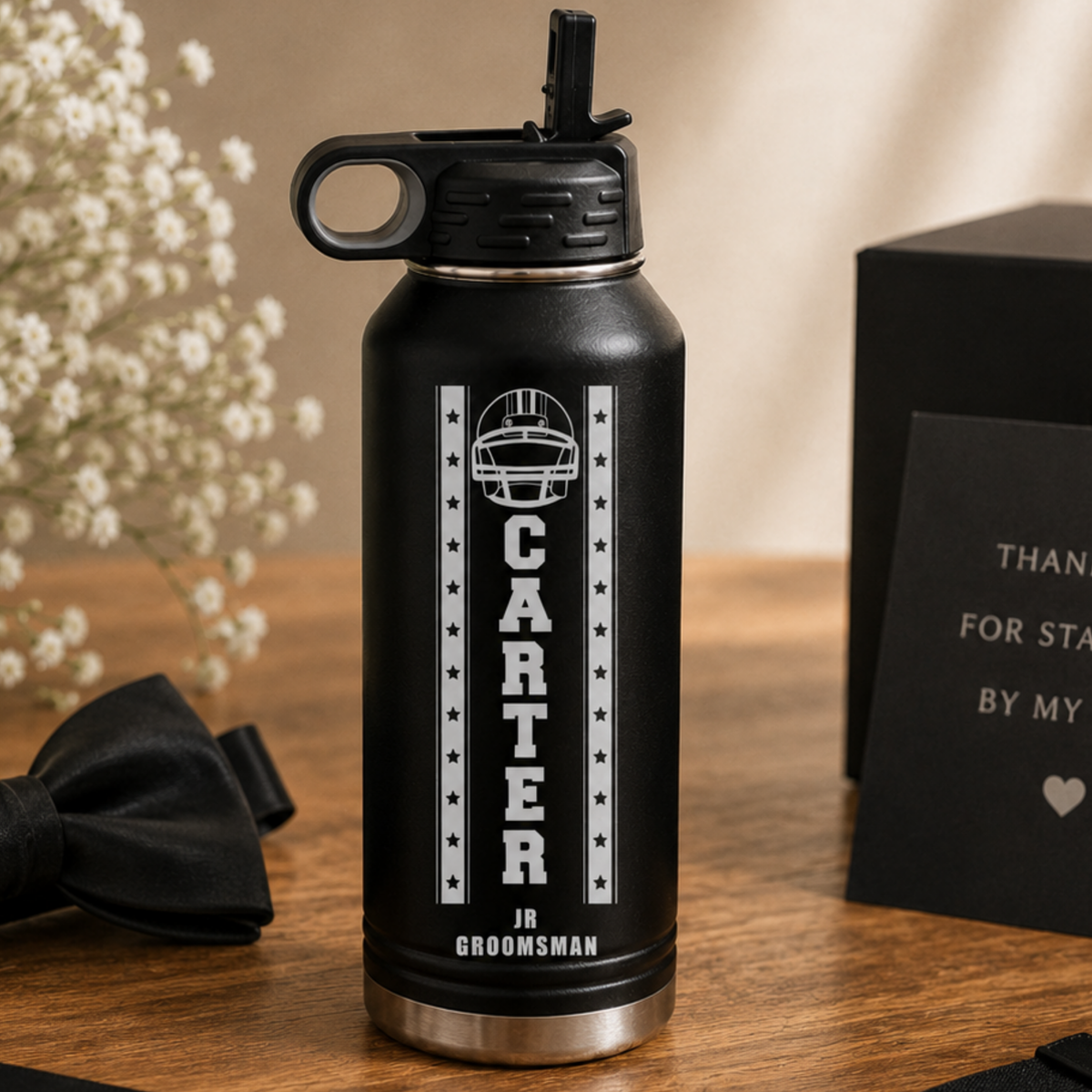 Black insulated water bottle with sample personalization reading "CARTER" and "JR GROOMSMAN" with football helmet and stars design
