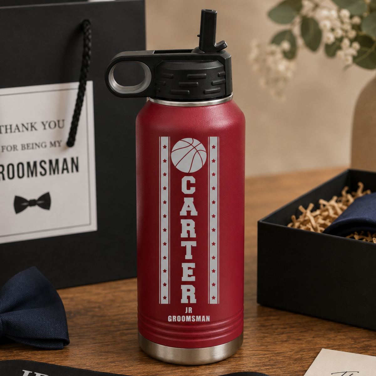 Red insulated water bottle engraved with basketball design and sample personalization reading "CARTER JR GROOMSMAN