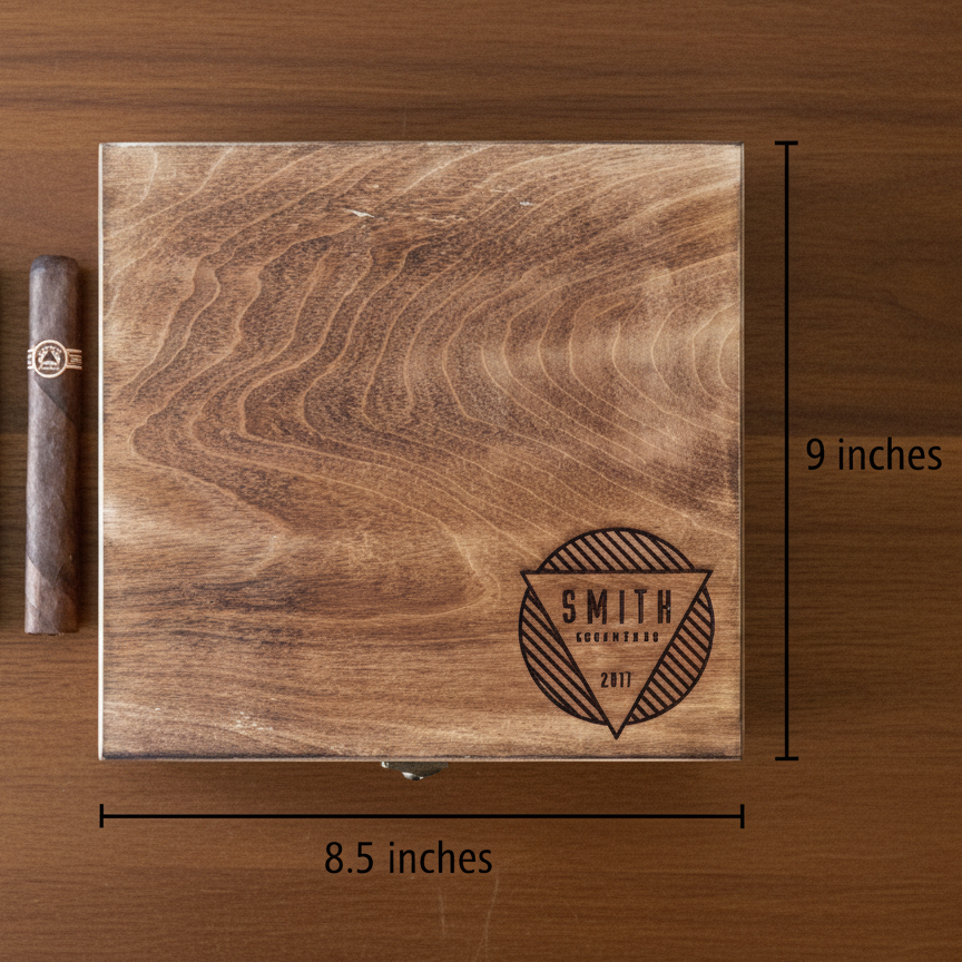 Birch wood cigar box with personalized laser engraving showing sample name "SMITH" with decorative badge and year "2011", displayed open with dimensions of 8.5 by 9 inches