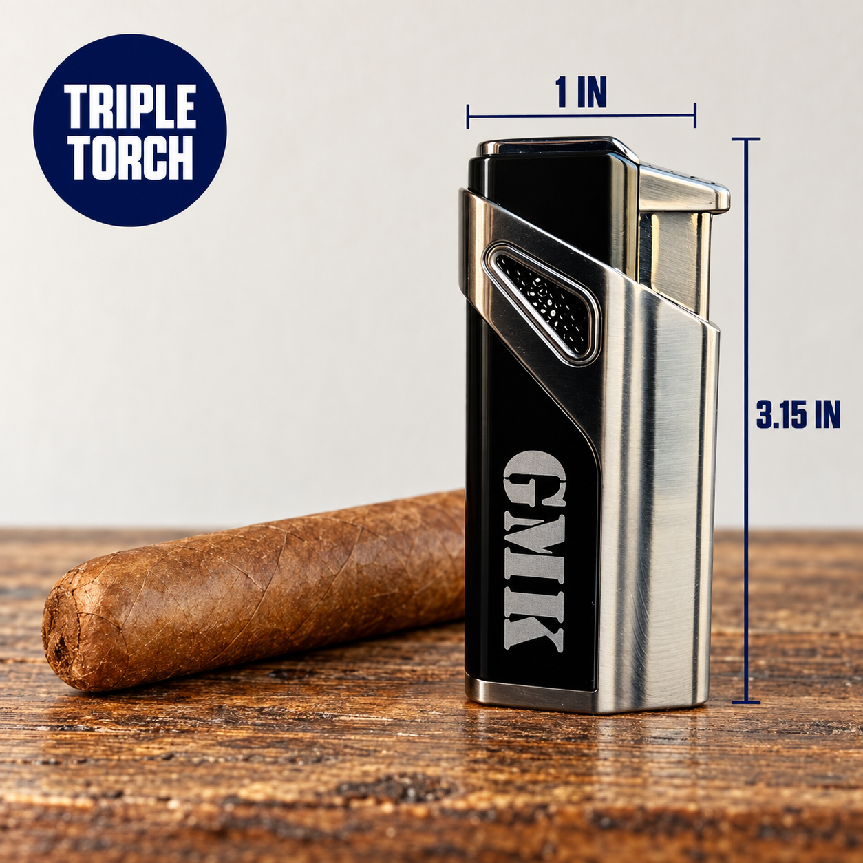 Engraved GMK torch lighter beside a plain cigar with lines marking 3.15 inches tall and 1 inch wide, and a badge noting its triple torch flame