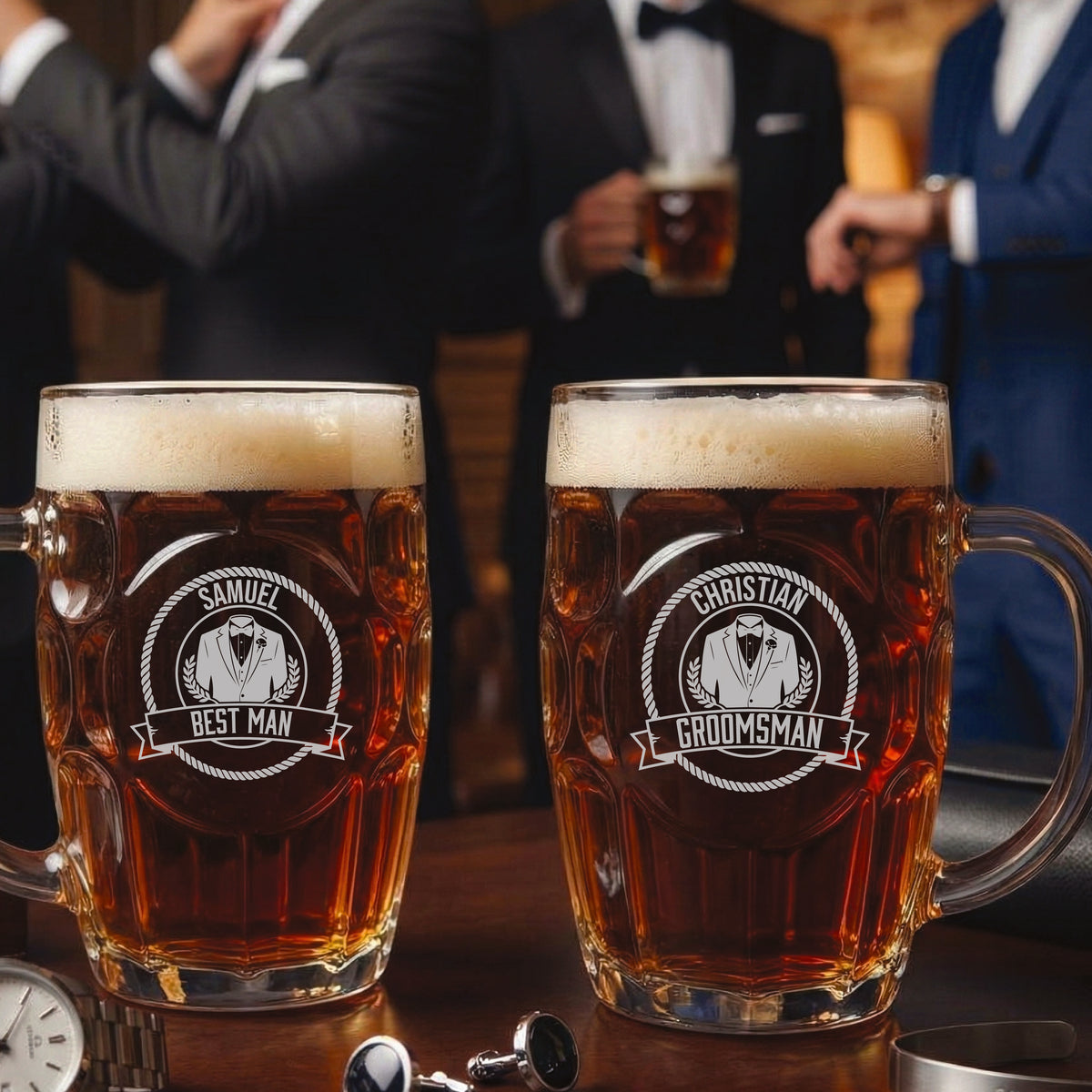 Two personalized beer mugs filled with beer, one engraved with sample name "Samuel" and "Best Man" title, the other with sample name "Christian" and "Groomsman" title, displayed in front of men in formal attire.