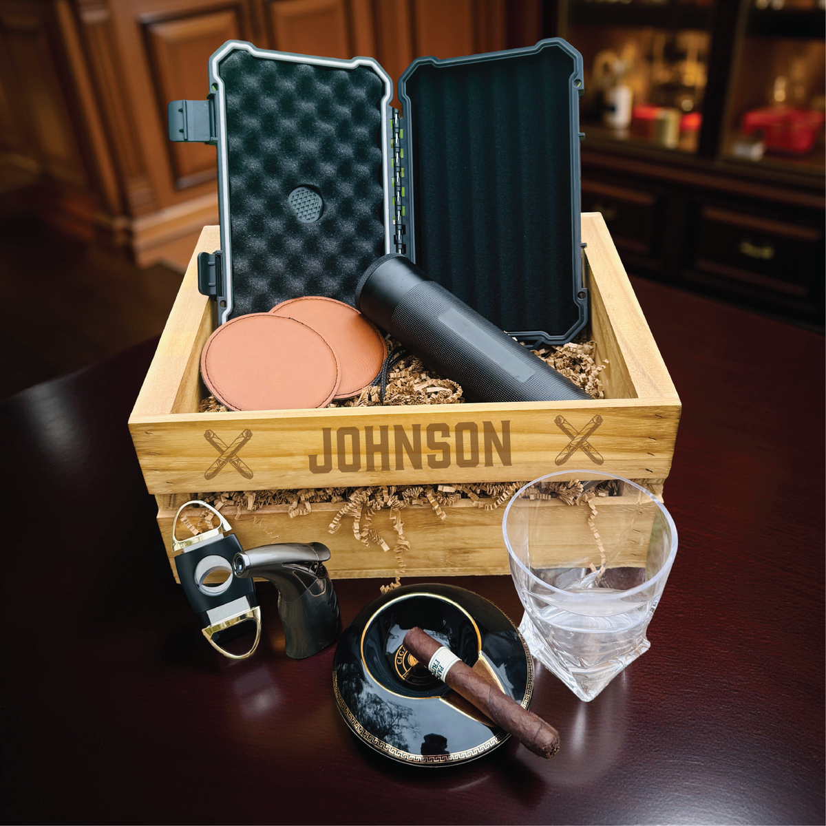 Ultimate personalized cigar gift set with engraved wooden crate, whiskey glass with cigar holder, and humidor for groomsmen.