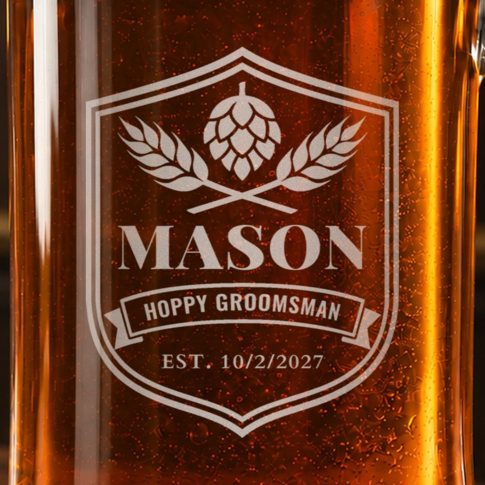 Close-up of the frosted craft beer label engraving on a groomsmen stein: hops and barley, the name Mason, Hoppy Groomsman and Est. 10/2/2027