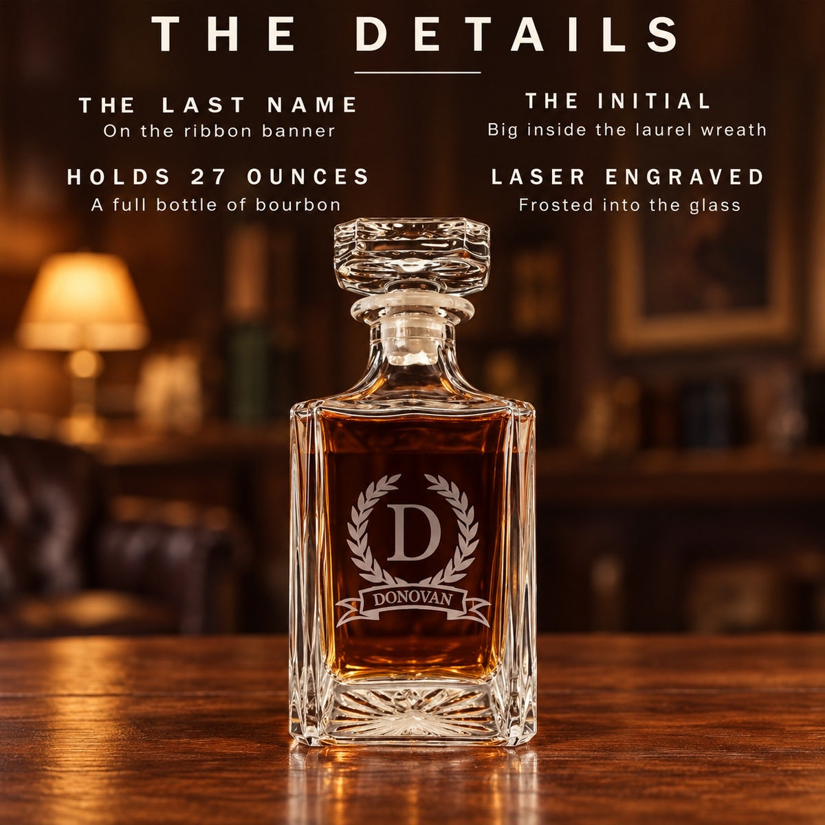 The details of the custom decanter: the last name on a ribbon banner, the initial big inside a laurel wreath, holds 27 ounces, laser engraved glass
