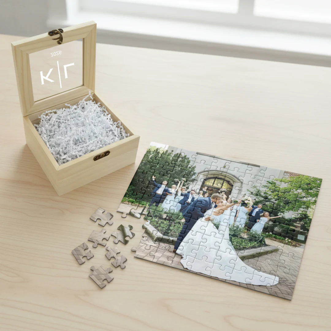 Wooden box with a personalized puzzle featuring a wedding scene on a wooden surface.