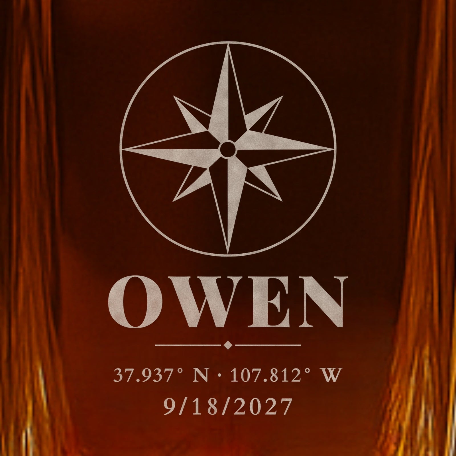 Close-up of frosted engraving on a whiskey decanter for the groom: a compass rose, the name Owen, Telluride wedding coordinates and the date 9/18/2027