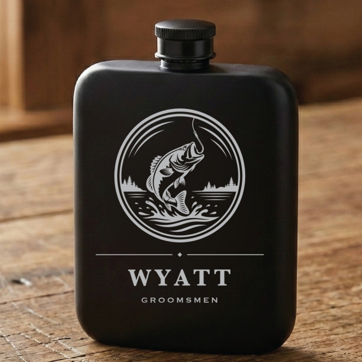 Matte black fishing groomsmen flask laser engraved with a leaping bass above the name Wyatt and the word Groomsmen.