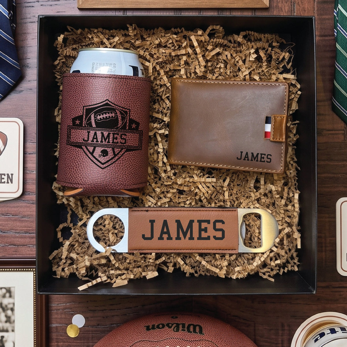 Overhead view of a football draft groomsmen proposal box packed in crinkle fill, with neckties and a football beside it ready to hand to the wedding party.