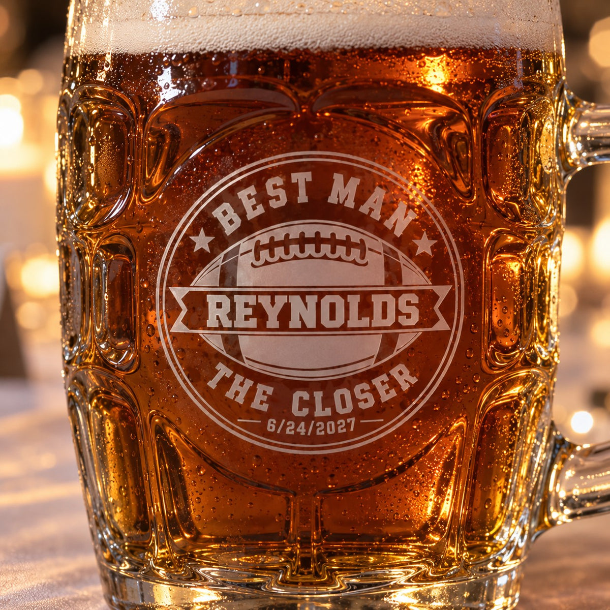 Close view of the frosted laser engraving on a personalized groomsman beer stein, a football crest reading Best Man, Reynolds, The Closer, 6/24/2027